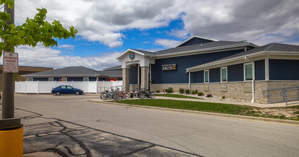 The Solutions Center operates within the St. Katharine Drexel - Fond du Lac homeless shelter. This picture is of the outside building front entrace visible from the East side of parking lot on 05/20/2026.
